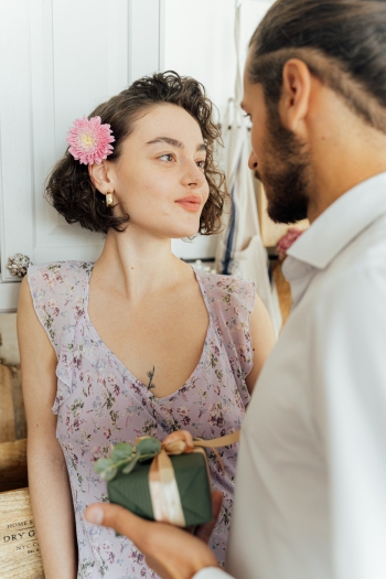 An escort meeting a client wearing a flowery dress
