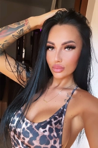 Kira taking a selfie in a leopard print bikini